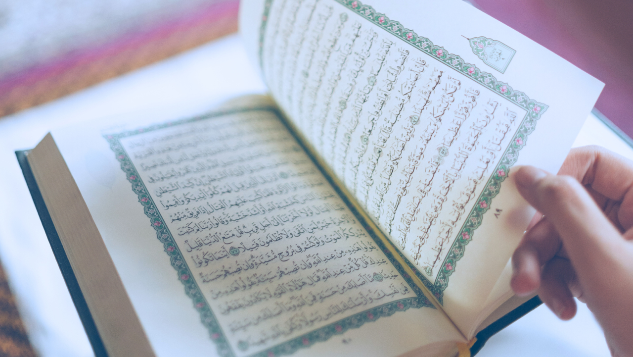 Hand turning page in Quran